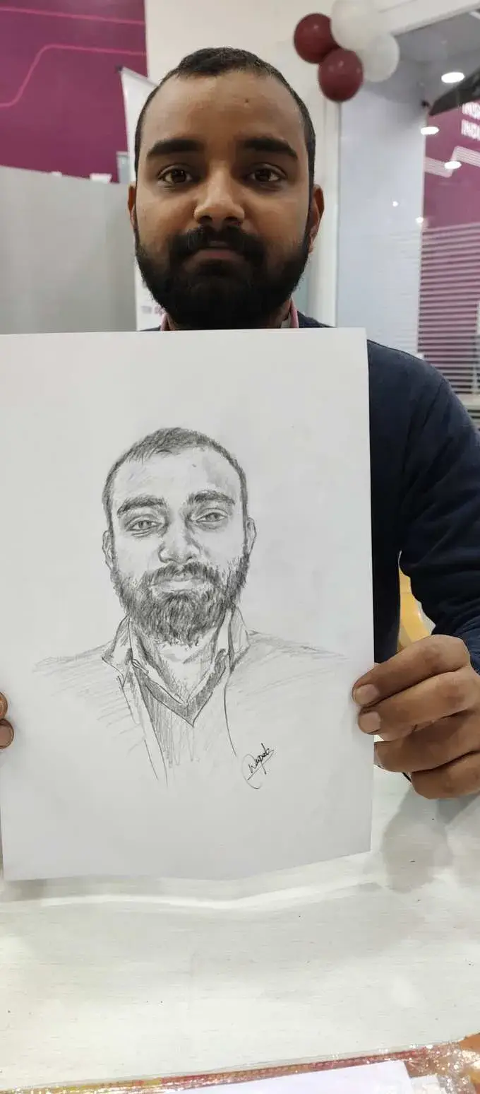 Happy customer holding pencil portrait by Deepak - live sketch event